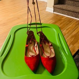 Red ballet shoes with gold embellishments